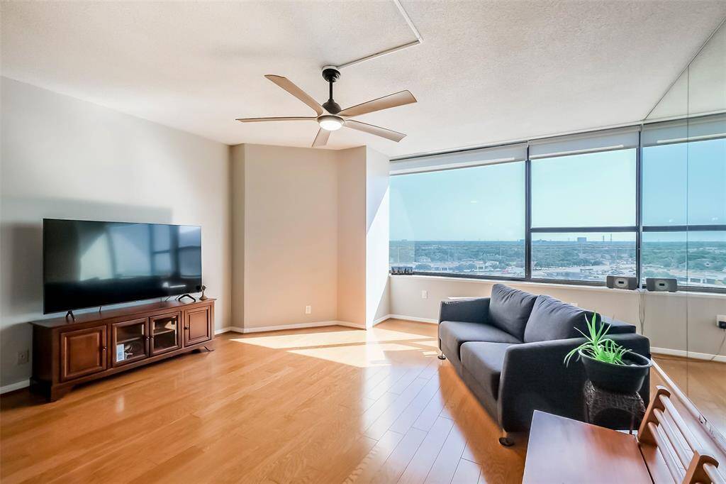 The living area is flooded with light and southern views from the 11th floor.