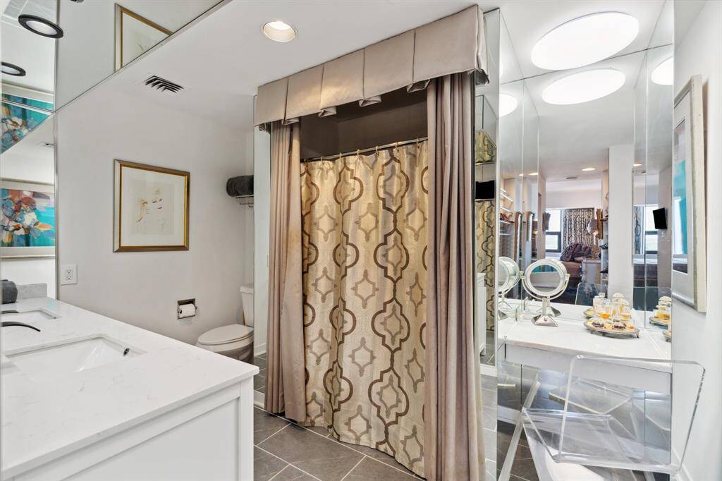 Primary bathroom with Quartz counters and vanity.