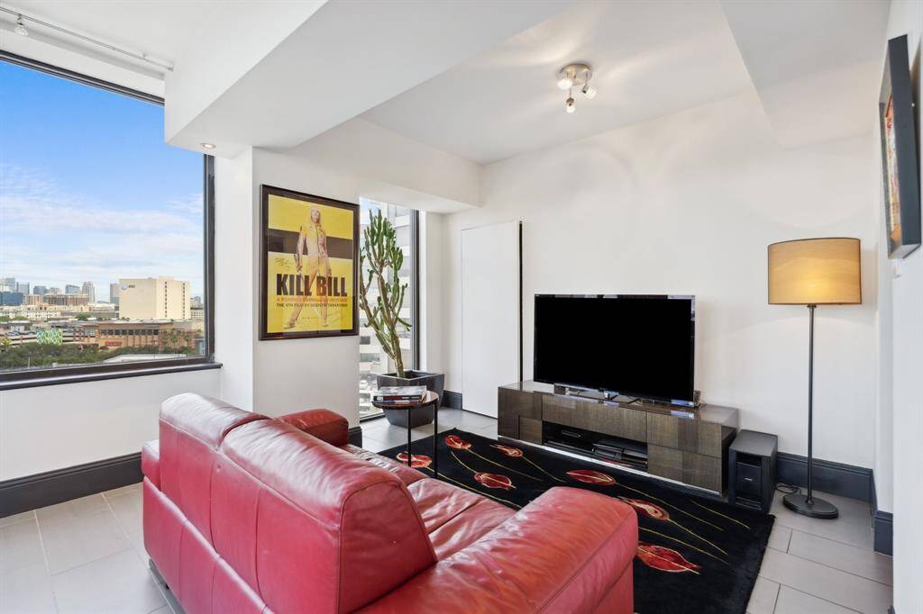 Den with access to a large walk in storage closet.