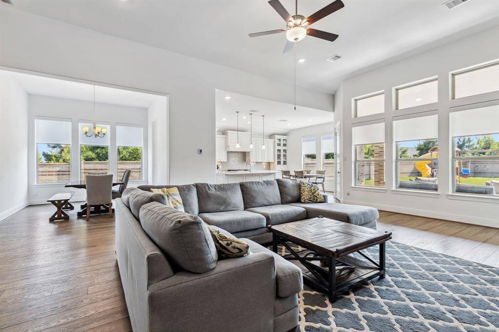 Living room opens to dining, kitchen and breakfast with views into the extra large yard.