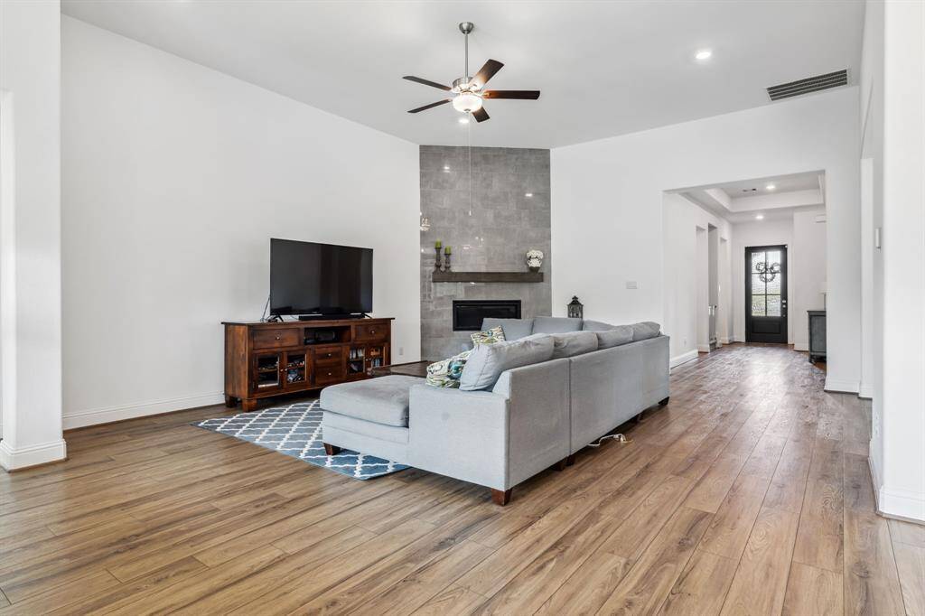 Fireplace is show stopper in this room.  Gorgeous polished gray tiles go all the way up to the ceiling with a nice wood mantel perfect to hang stocking!