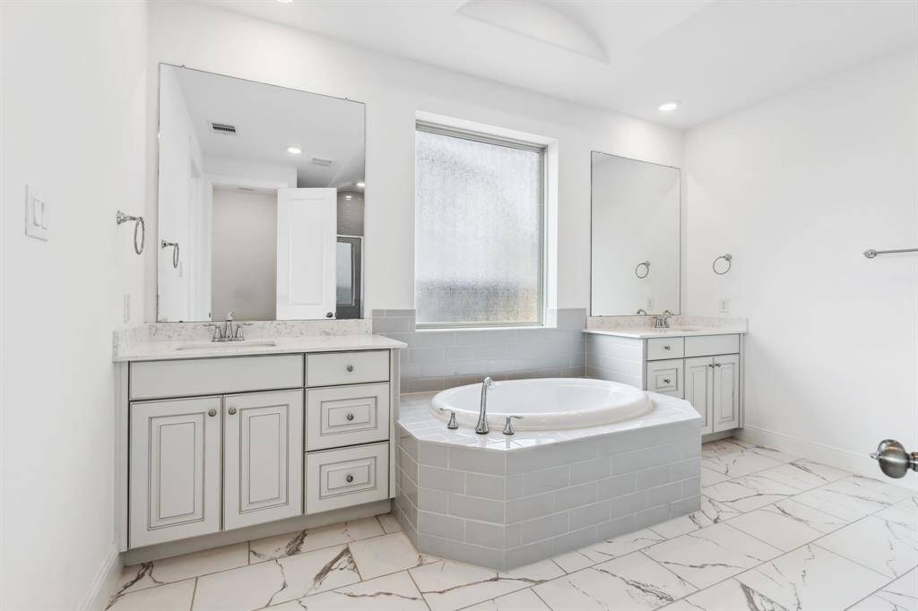 Primary bathroom is a dream!   Huge soaking tub plus a big walk-in shower and just wait until you see the closet !