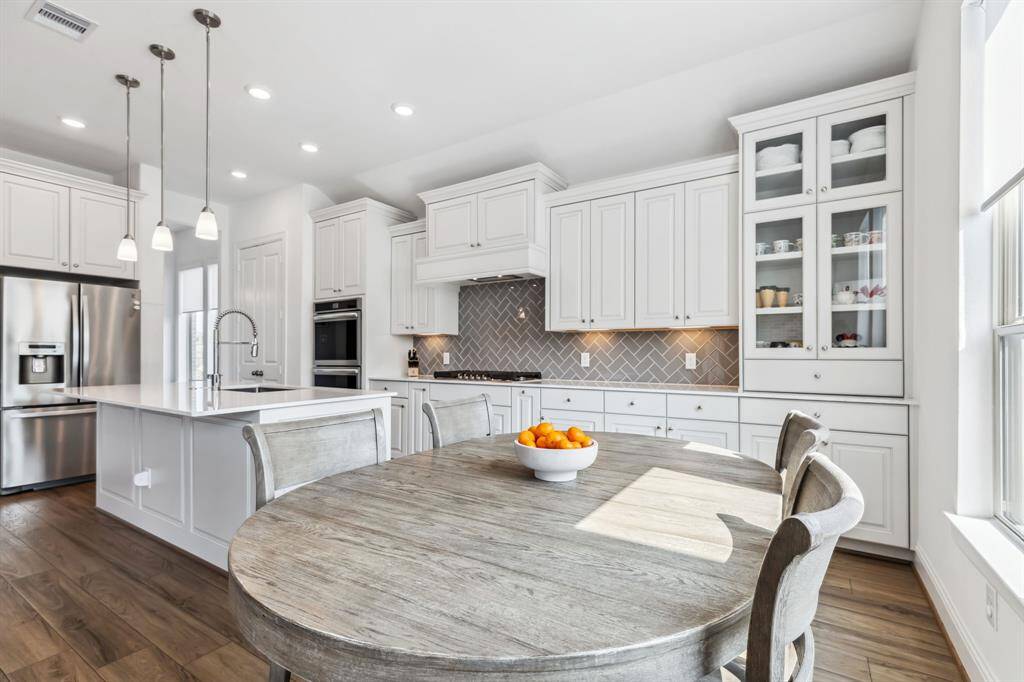 Island kitchen with gas cook range nice high ceiling, big pantry and plenty of cabinets for storage is any chefs dream!