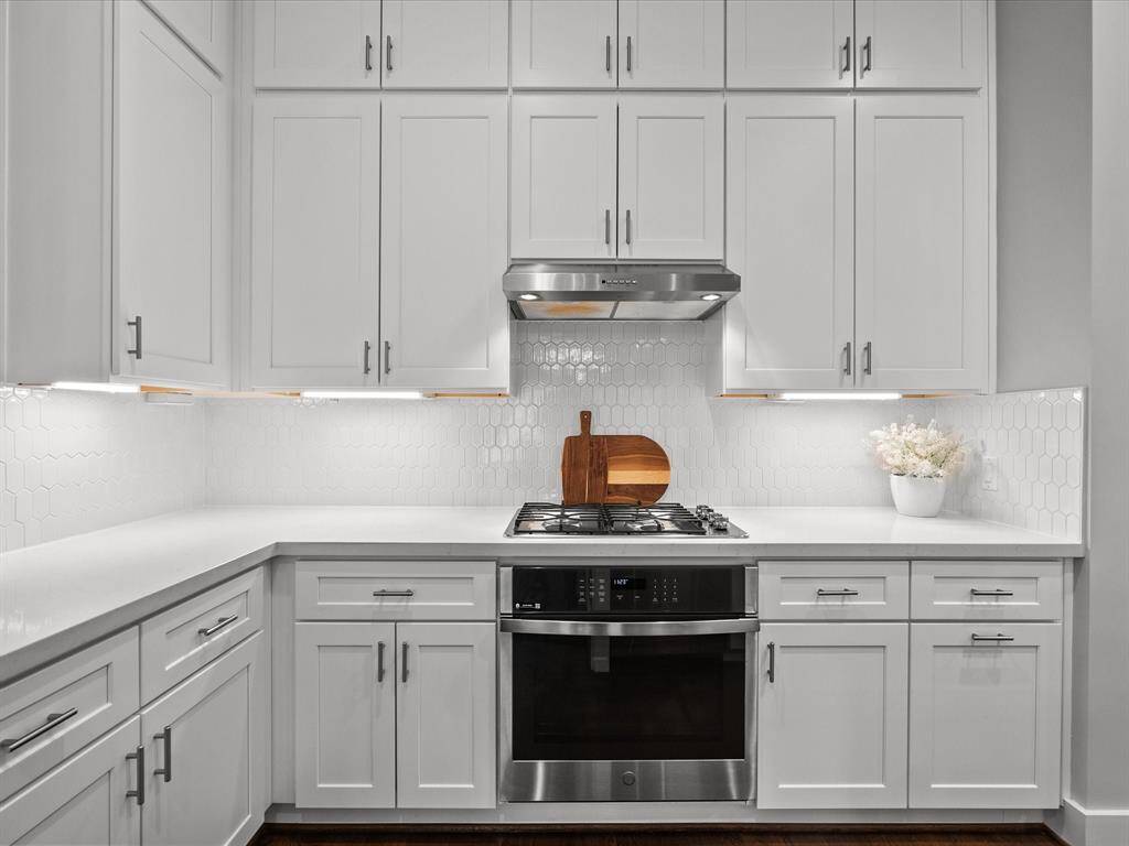 A chef's kitchen with high end stainless steel appliances.