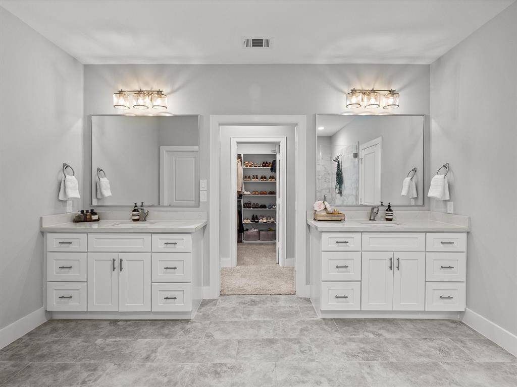 Primary bathroom features a spacious glass-enclosed shower and a freestanding bathtub.