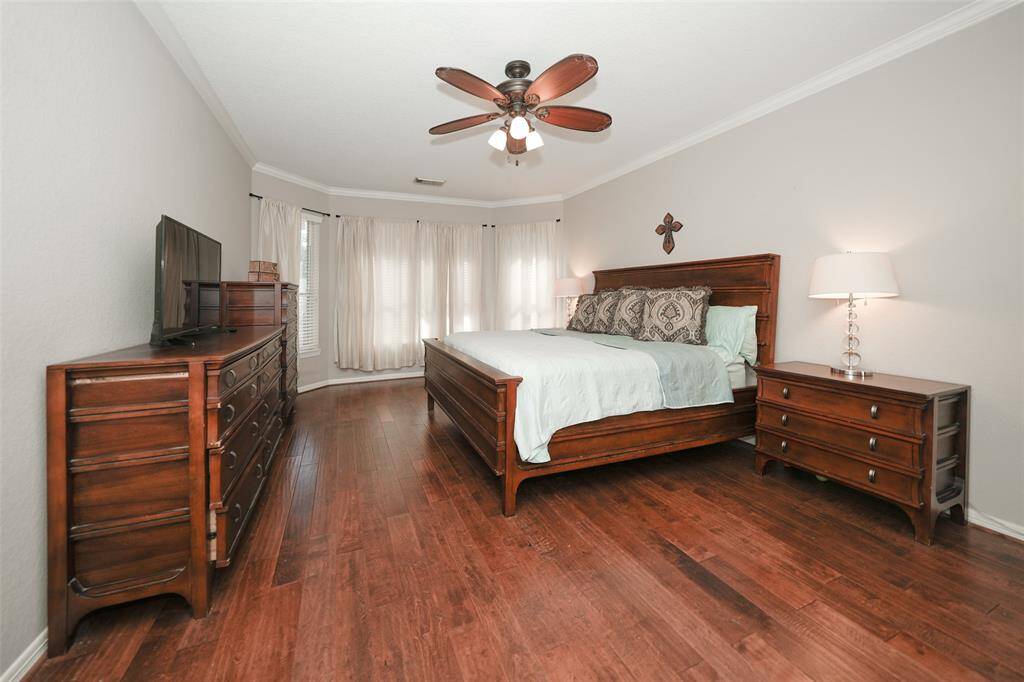 First floor primary bedroom with hardwood floors