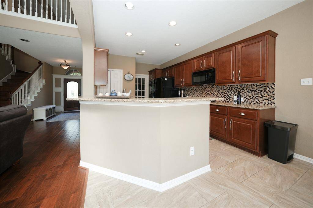 View of entryway, kitchen, and living room