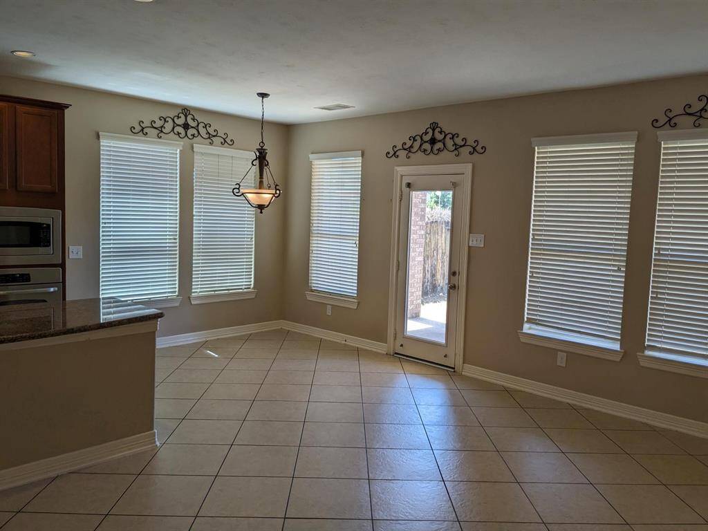 Bright and inviting breakfast room with ample natural light and convenient access to the backyard.