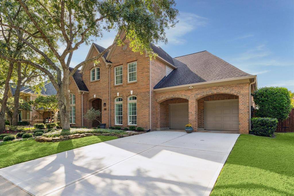 Double driveway with a three car tandem oversized garage.