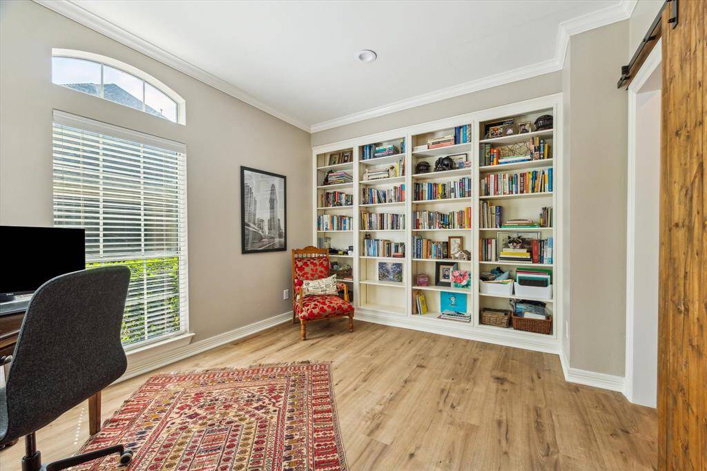 Downstairs study with built-in shelves and barn door.