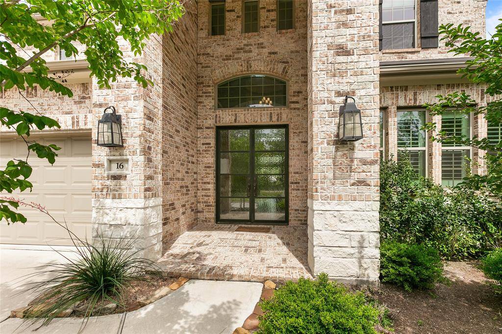 Stunning curb appeal with modern brick and stone façade, manicured landscaping and a welcoming front porch.
