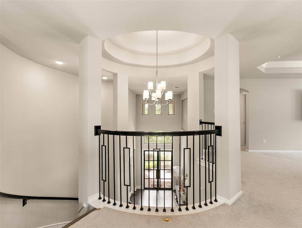 Ascend the winding staircase for a beautiful view of the entryway.