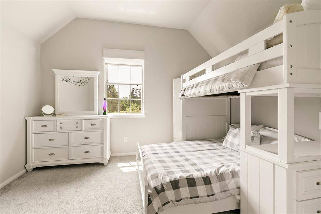 Charming third bedroom with soft natural lighting and bunk bed.