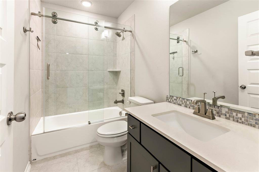 Upstairs bathroom with sleek shower-tub combo.