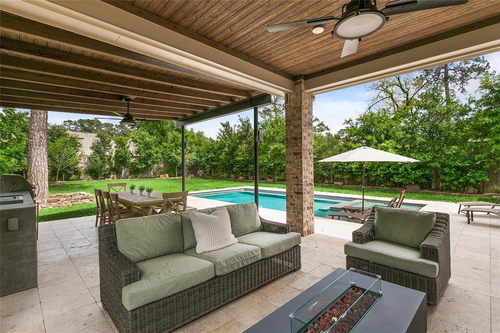 Covered patio leads directly to the sparkling pool, creating the perfect indoor-outdoor lifestyle setup.