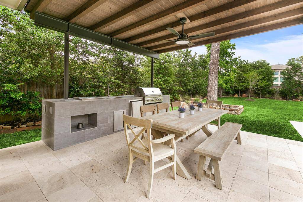 Enjoy al fresco dining under the spacious covered patio, complete with ceiling fan and full outdoor dining set—perfect for weekend brunches, evening meals or entertaining under the Texas sky.