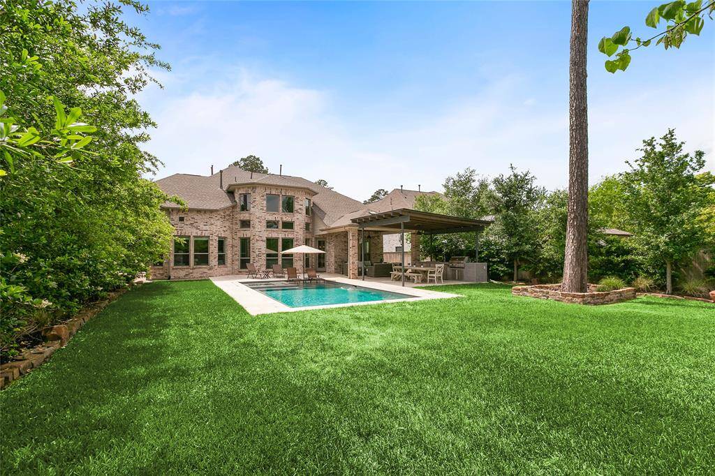 Sparkling pool surrounded by lush greenery and privacy fencing, perfect for unwinding or entertaining.