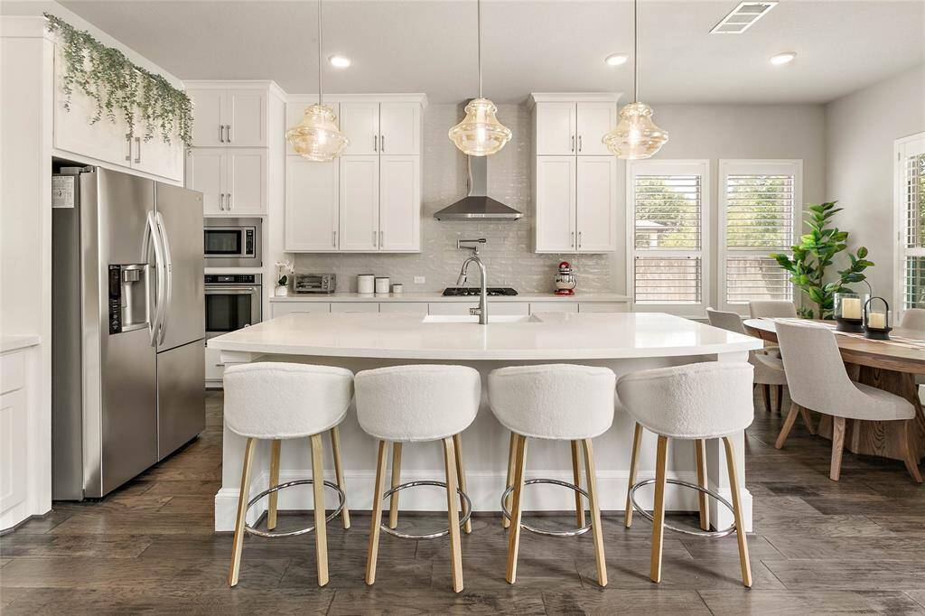 The heart of the home—an incredible gourmet kitchen with quartz counters, subway tile backsplash and upgraded cabinetry.