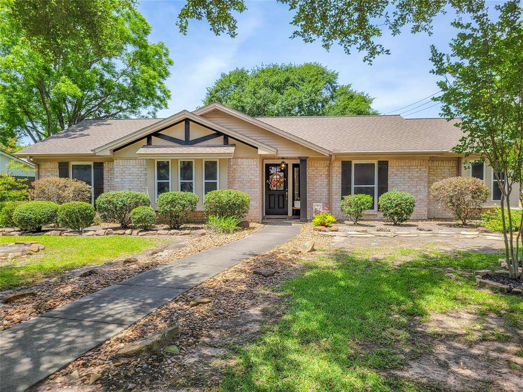 Charming single-story brick home with a welcoming front entrance, well-maintained landscaping, and mature trees. Ideal for buyers seeking comfort and curb appeal.