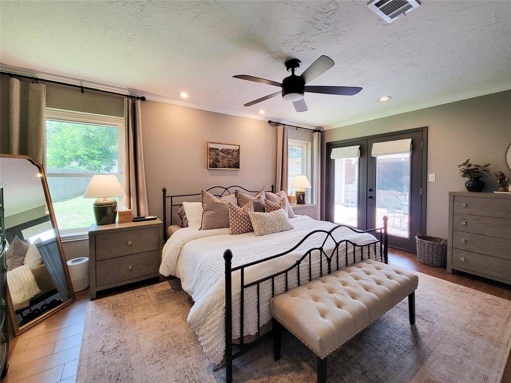 This bedroom features a door leading outside to the patio.