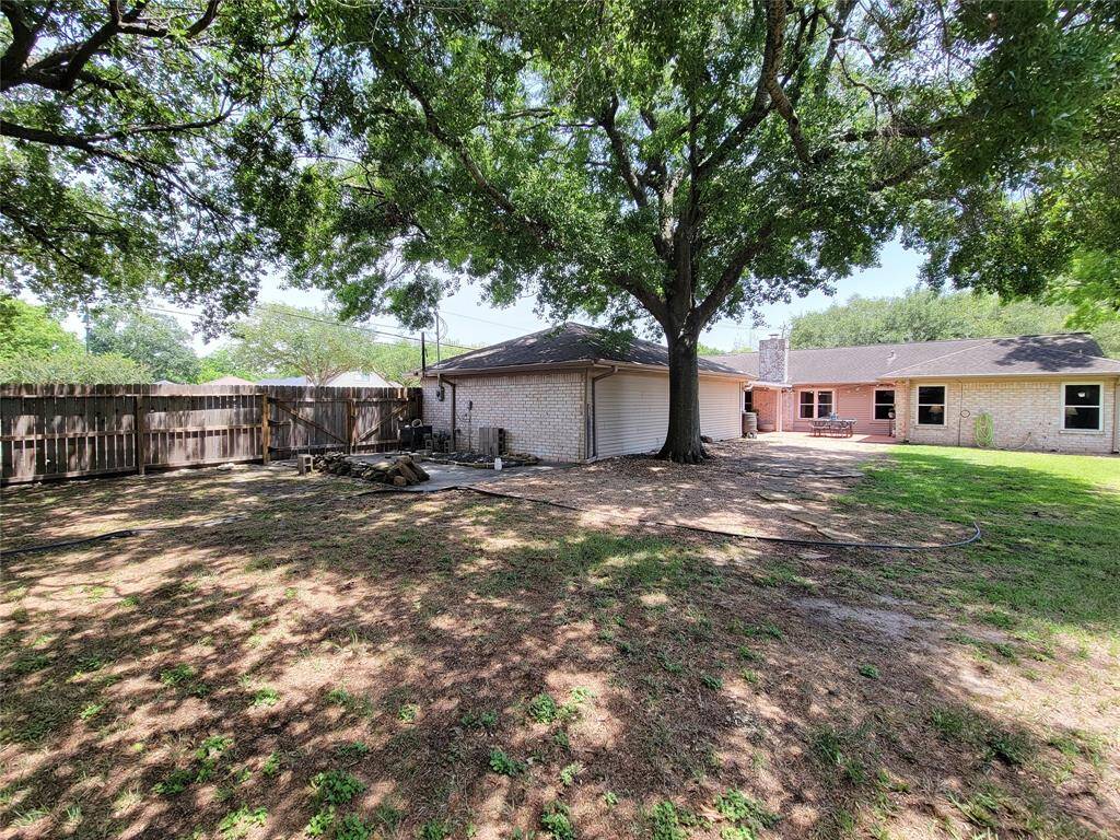 There is an extra concert area where you could store a boat or an RV in this spacious backyard.