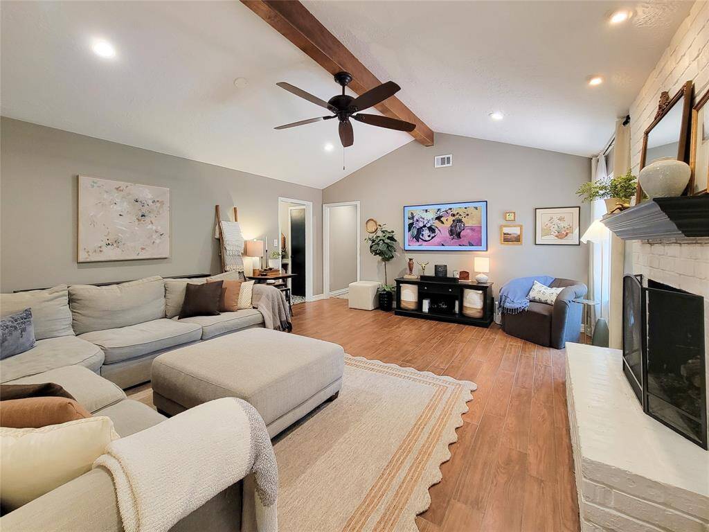 Another view of this inviting living room featuring a high ceiling with exposed beam.