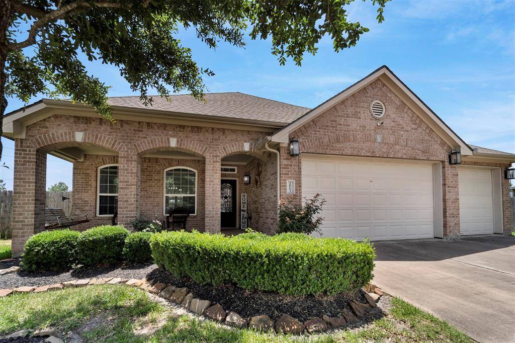 Brick exterior, covered porch, and landscaped yard.