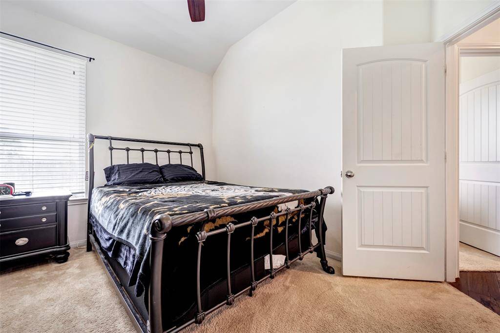 This spacious bedroom features abundant natural light and plush carpeting throughout.