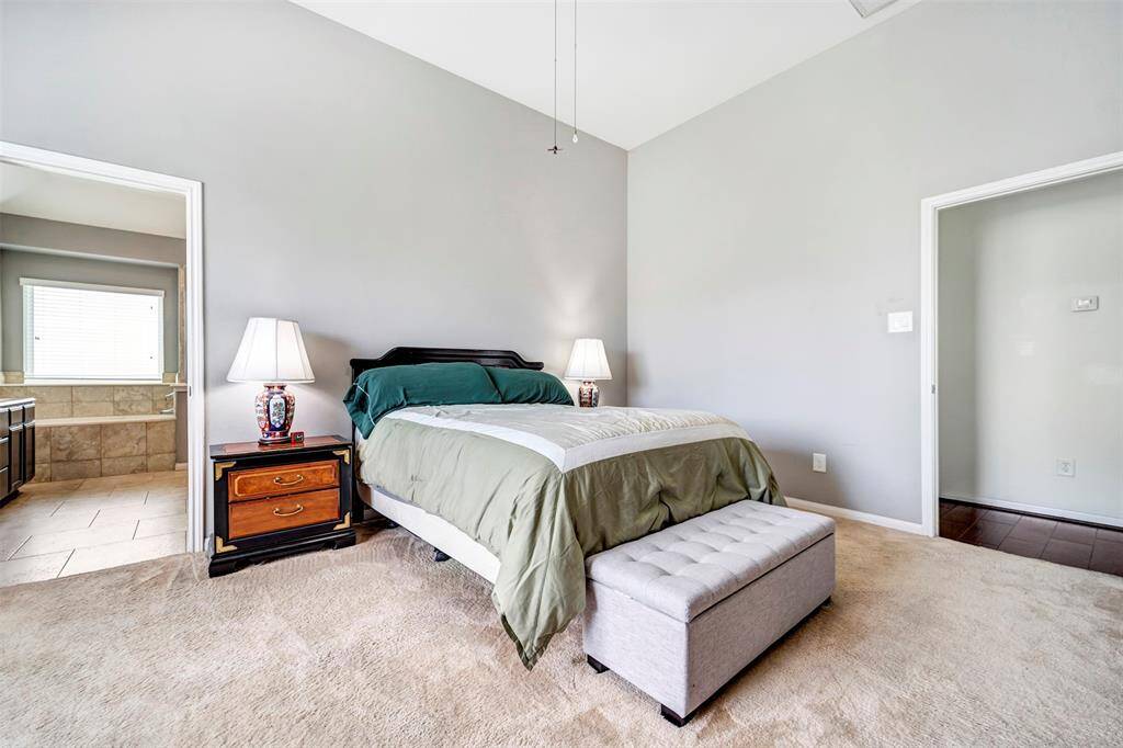 This spacious bathroom features ample counter space and tile flooring.