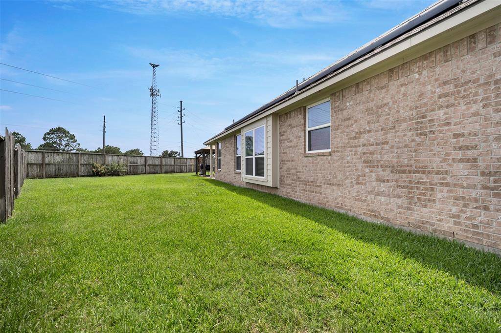 Spacious yard with covered patio and ample greenspace.