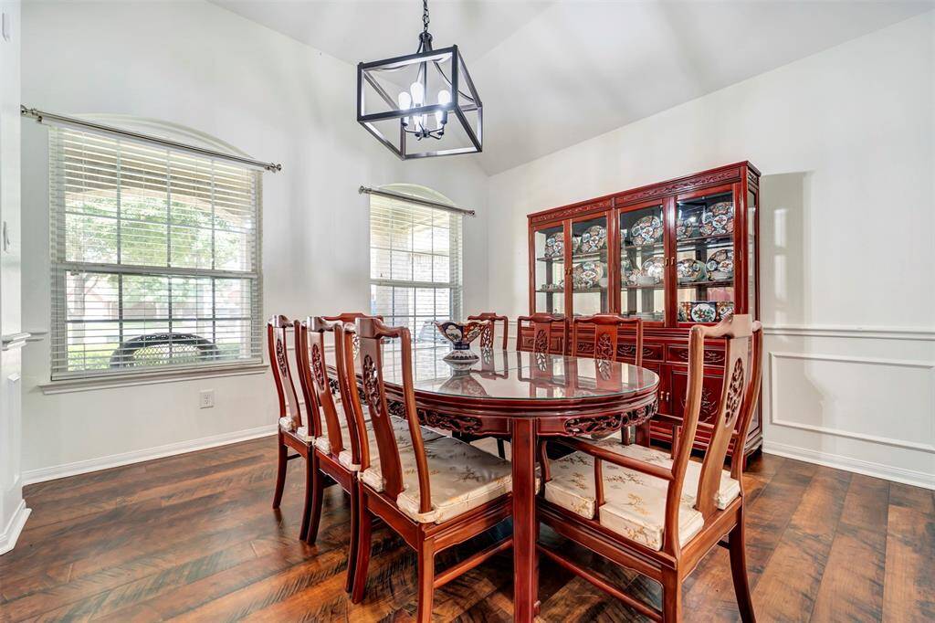 This spacious dining area features elegant architectural details and beautiful hardwood flooring.