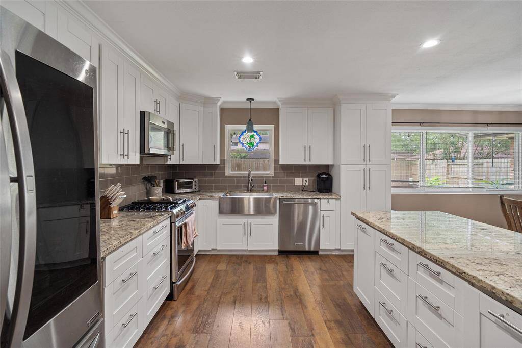 Beautiful flooring throughout, granite countertops and plenty of storage space