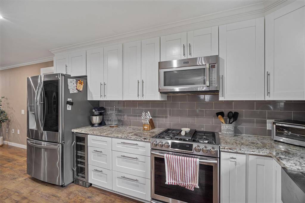 Granite countertops, stainless steel appliances, separate wine/beverage fridge