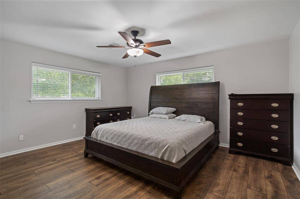 Primary bedroom with modern flooring