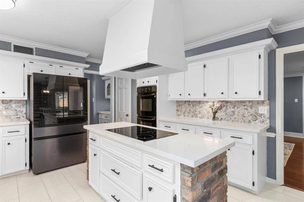 Fresh paint, upgraded Quartz countertops, backsplash, and hardware set the stage for all of your meal prepping or take-out unpacking. Double ovens are ready and waiting for your holiday get-togethers. The kitchen flows into the living room to your right and to the Butlers Pantry and Dining Room to your left.