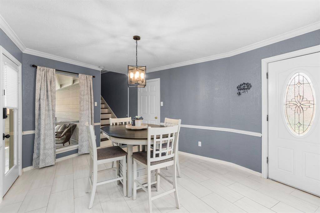 Updated neutral tile floors are attractive and low-maintenace, and flow from the breakfast room to the kitchen.