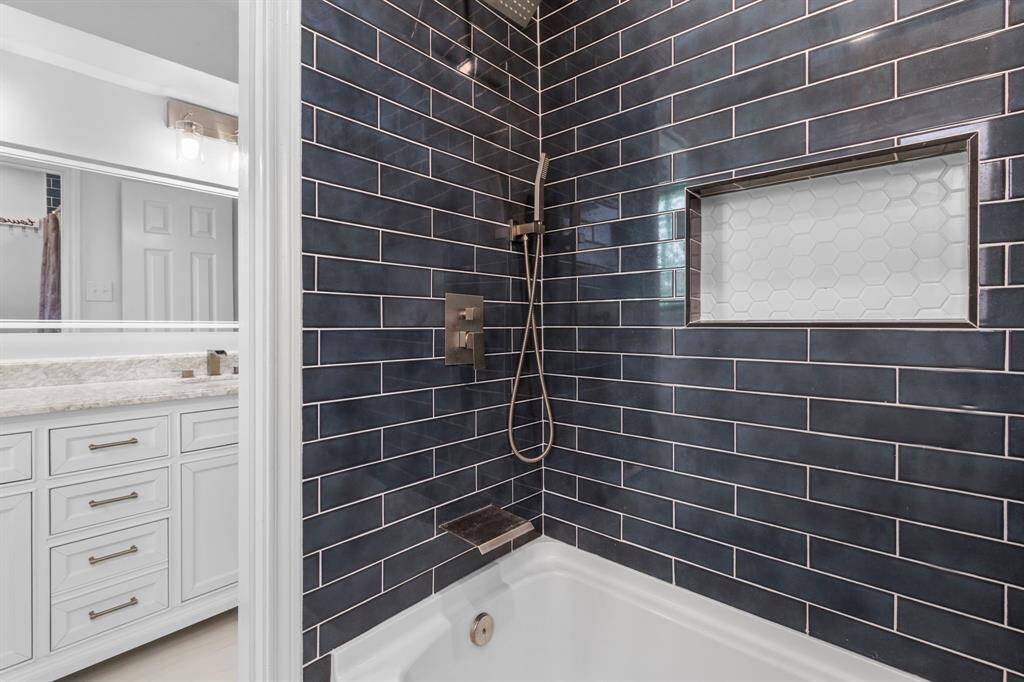 The upstairs secondary bathroom is often an overlooked room in older homes. That is NOT the case here! The impeccable materials selections in this bath will stand the test of time. The dual shower heads and upscale faucet are standouts!