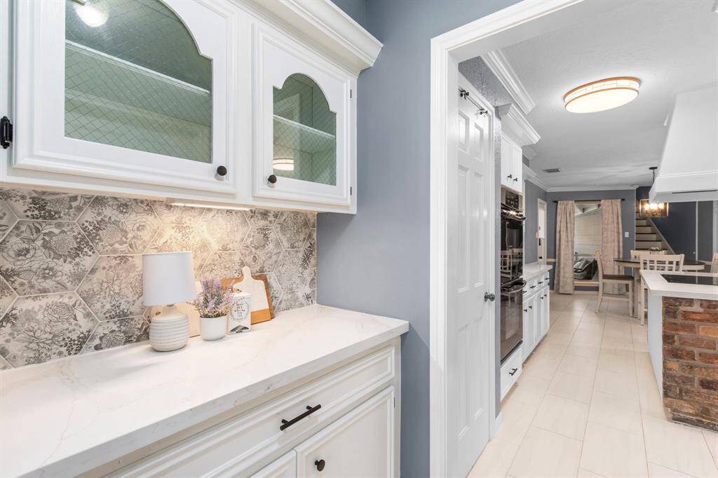 The Butler's Pantry echoses the materials used in the kitchen, and is ideally located between the kitchen and the dining room. Just across the hall is the utillity room