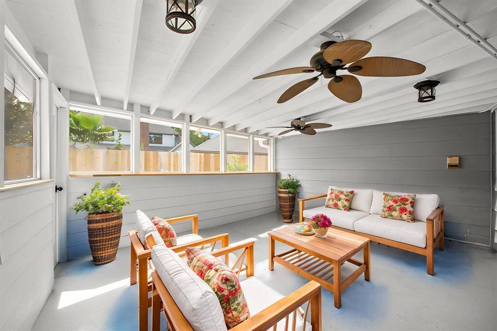 The enclosed back patio is shown furnished for lounging. This space could also make a great outdooor dining space. Screened openings allow views out to the pool without allowing mosquitoes to join in the fun. Enjoy outdoor entertaining in any weather here!