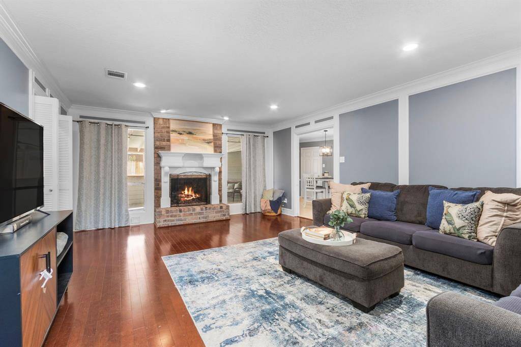 The first floor living room overlooks the enclosed back patio.