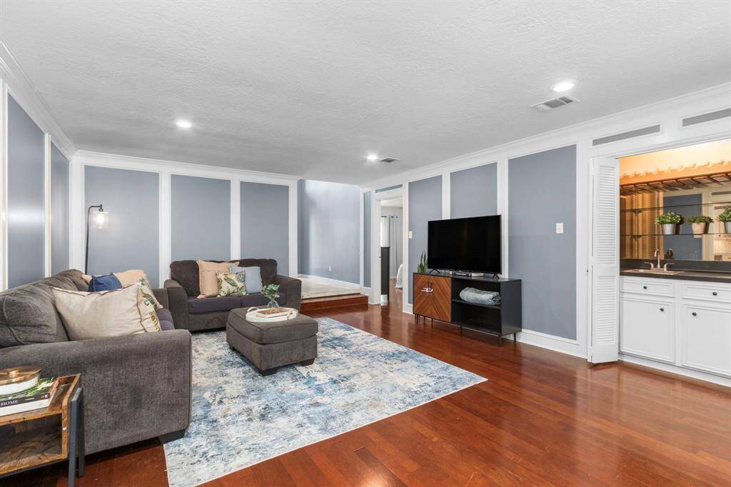 The living room is spacious and ready for your formal living furniture, or your comfiest sectional! A wet  bar is the perfect spot for wine storage or a coffee and snack bar.
