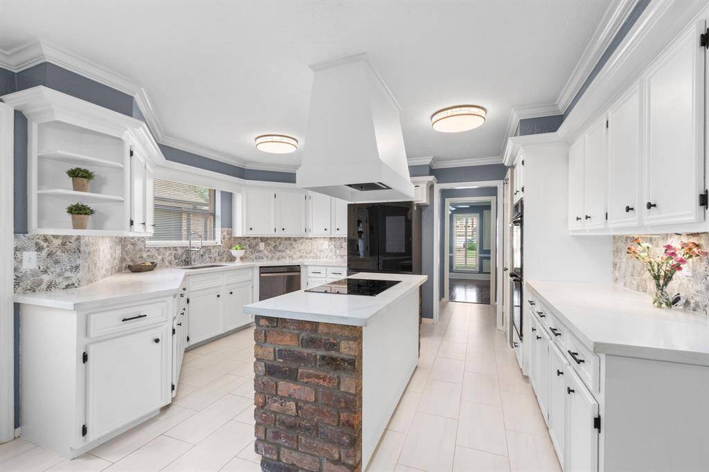 The updated kitchen boasts Quartz countertops, a brand new stainless steel dishwasher, double ovens, and loads of counter space!