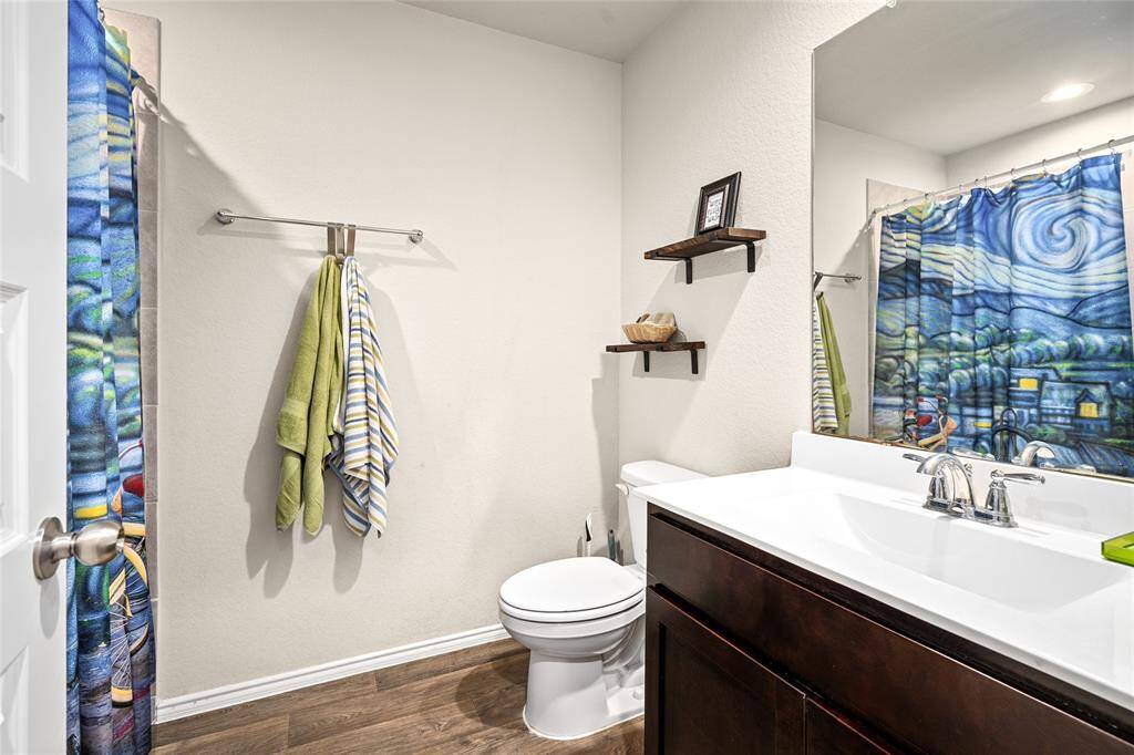 This secondary bathroom is conveniently situated between the additional bedrooms. It features a tub/shower combination and offers easy access for guests.