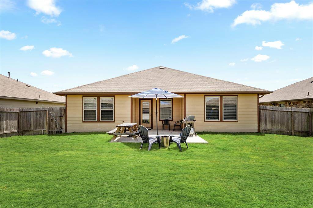 Enjoy the best of outdoor living in this oversized backyard, complete with a covered patio, grilling station, picnic area, and shaded seating under a large umbrella. The beautifully maintained, fully fenced lawn offers plenty of room for recreation, pets, or future landscaping dreams. Whether you’re hosting a summer cookout or enjoying a quiet evening under the stars, this versatile outdoor space is ready to accommodate every lifestyle.