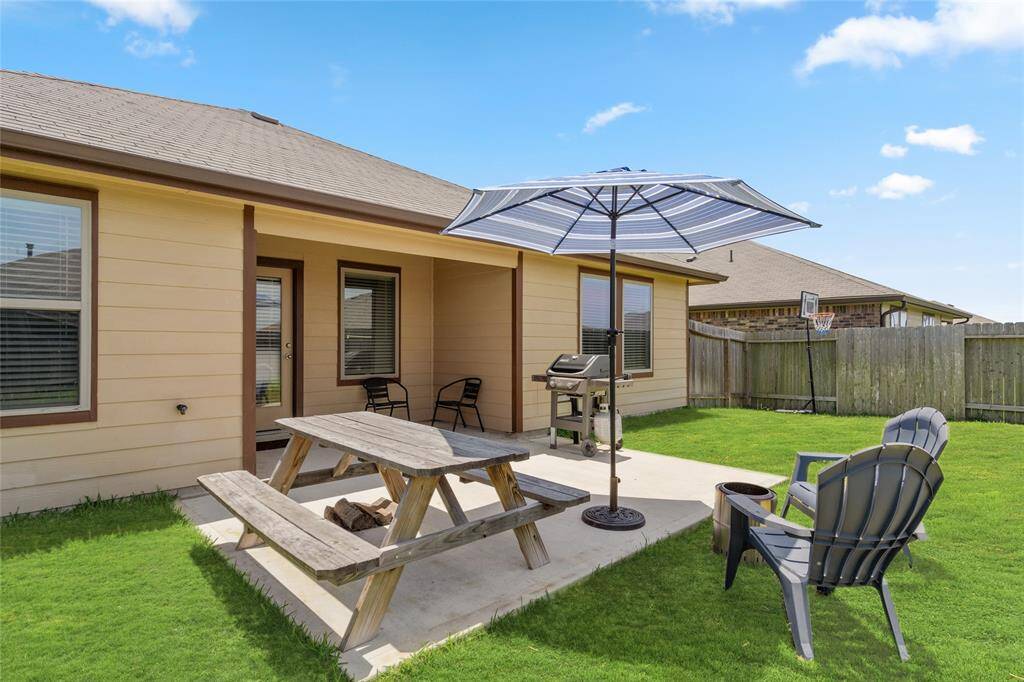 Step out to your private patio oasis—complete with a covered lounge area, grill station, picnic table, fire pit, and shaded seating. Whether it’s morning coffee or weekend cookouts, this backyard is built for relaxation and connection.