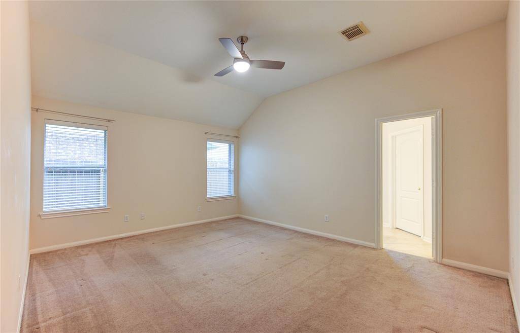 Bright and spacious primary bedroom is on one side of the house.