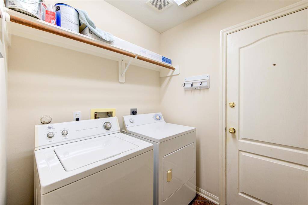 The laundry room, conveniently situated right across from the hall bath, leads into the 2-car garage. Please note, the seller is willing to leave the washer and dryer with the house.