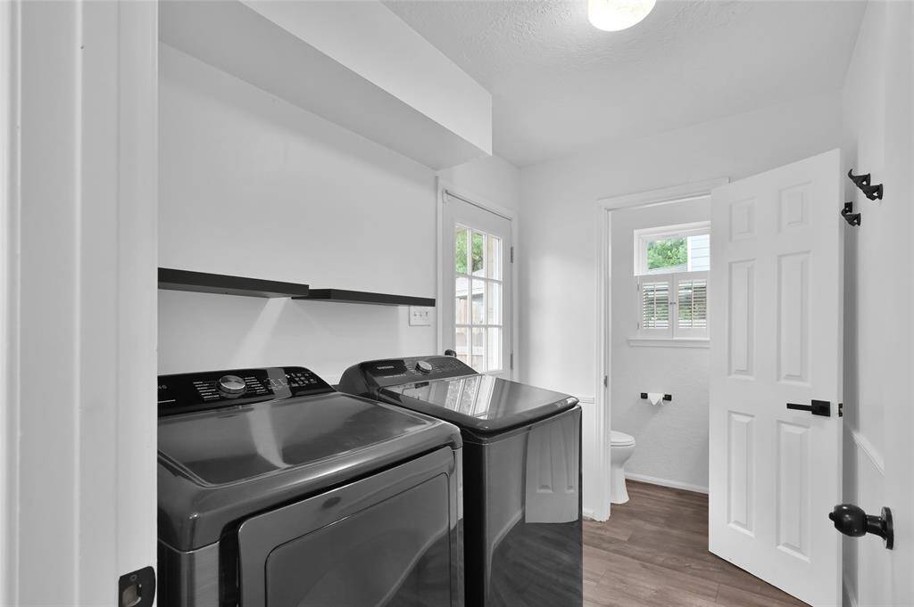 Back downstairs just off the Kitchen is the Laundry Room. A door also provides one of two ways to access the Back Yard.