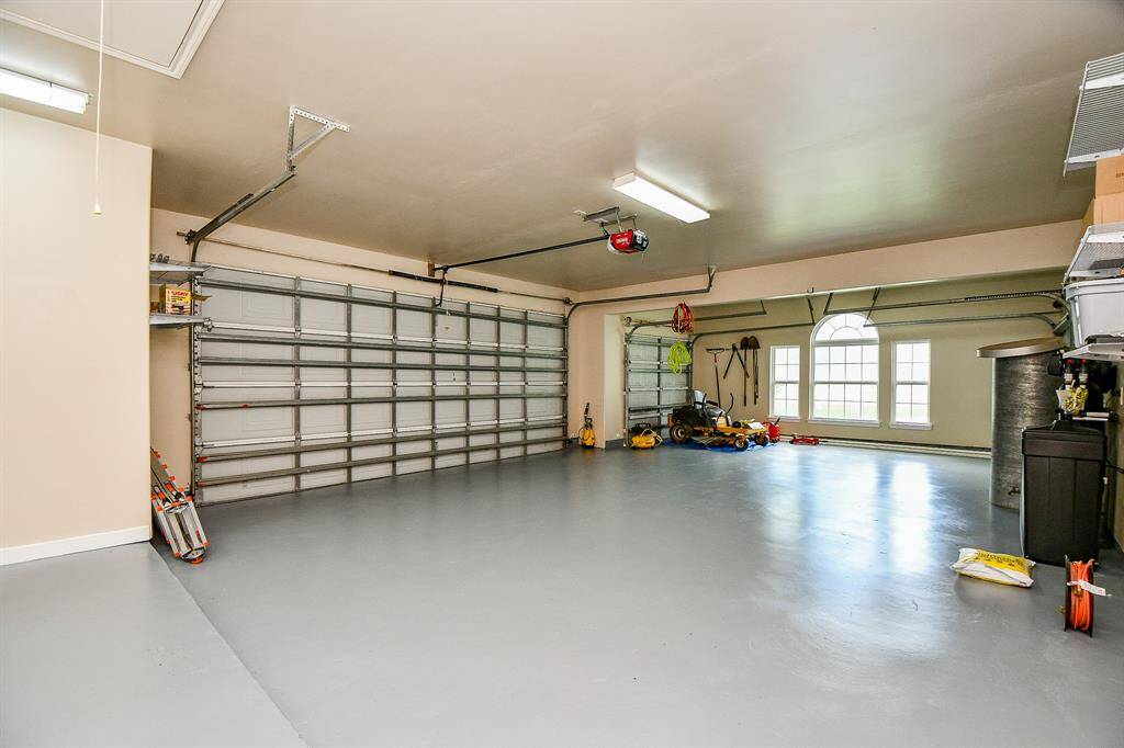 Oversized 3 car garage with 3 garage doors. The smaller one is a pass through.