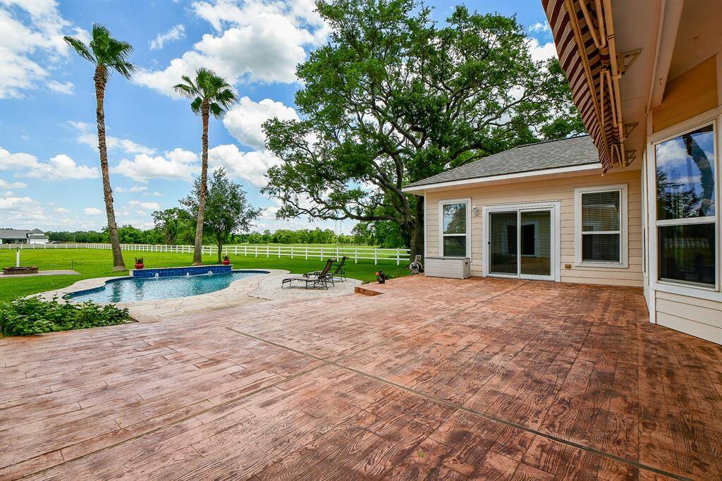 Oversized Stamped concrete patio with 3 entry points to the home